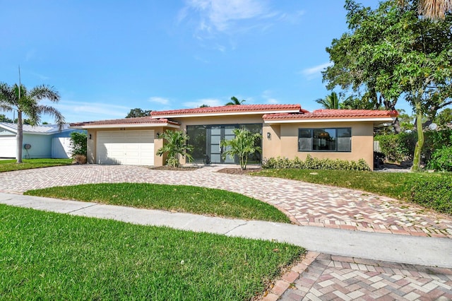 view of front of house with a garage and a front lawn