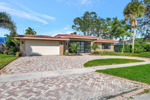 single story home with a garage and a front yard