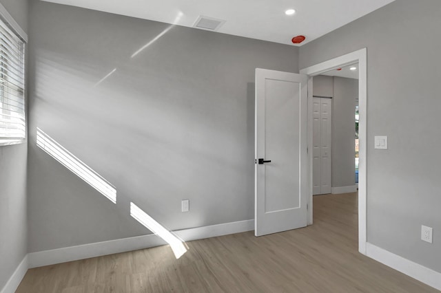 unfurnished room with light wood-type flooring