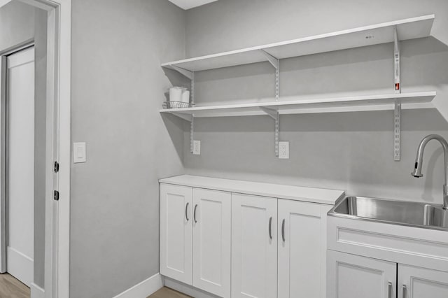 interior space featuring light wood-type flooring and sink