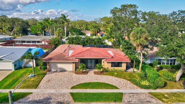 view of front of home with a garage and a front lawn