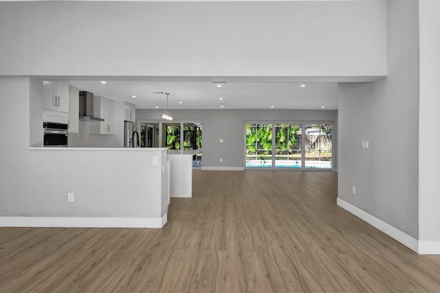 unfurnished living room with light hardwood / wood-style floors