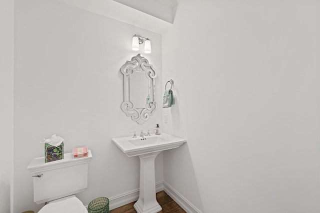 bathroom with toilet and wood-type flooring