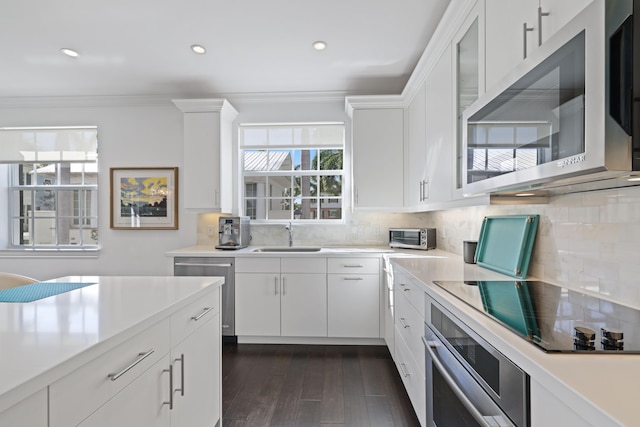 kitchen with white cabinets, sink, and appliances with stainless steel finishes