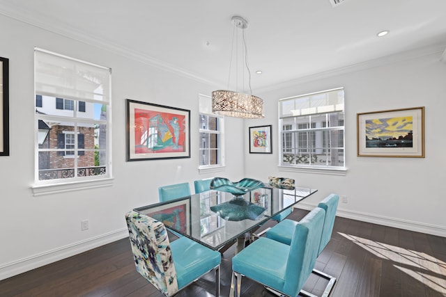 dining room featuring plenty of natural light, dark hardwood / wood-style flooring, ornamental molding, and a chandelier