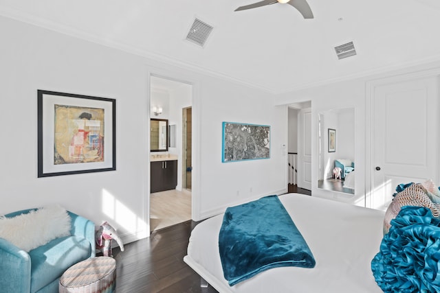 bedroom with ceiling fan, crown molding, dark wood-type flooring, and connected bathroom