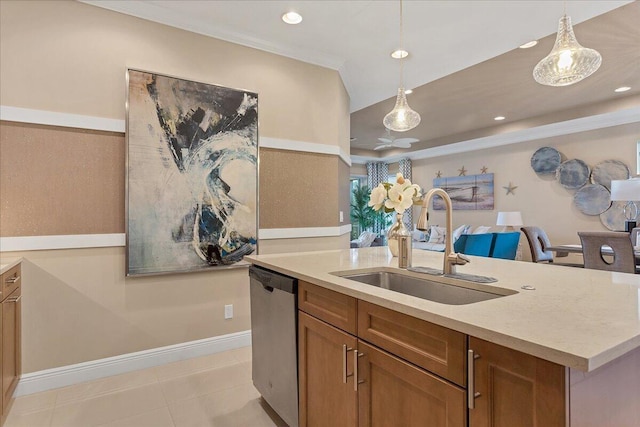 kitchen featuring brown cabinetry, an island with sink, stainless steel dishwasher, pendant lighting, and a sink