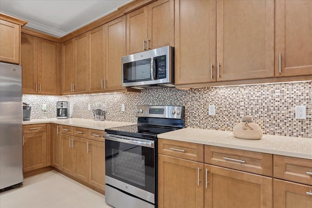 kitchen featuring tasteful backsplash, stainless steel appliances, and light countertops