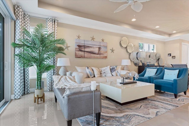 tiled living area with a tray ceiling, a ceiling fan, and recessed lighting