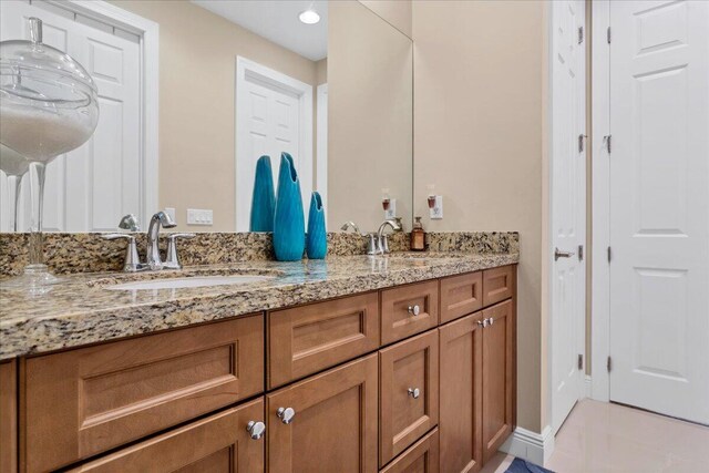 full bath featuring double vanity and a sink