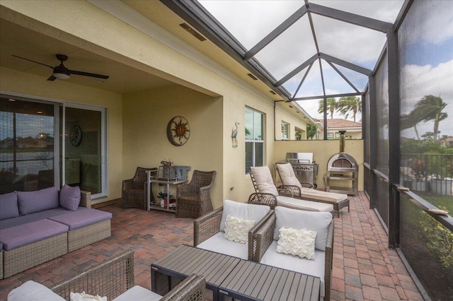 sunroom featuring ceiling fan