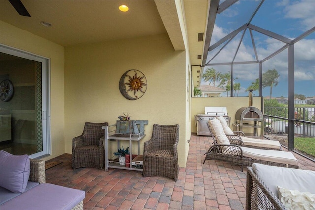 view of patio / terrace featuring visible vents, glass enclosure, and an outdoor living space