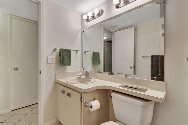 full bathroom with toilet, bath / shower combo with glass door, vanity, and tile patterned floors