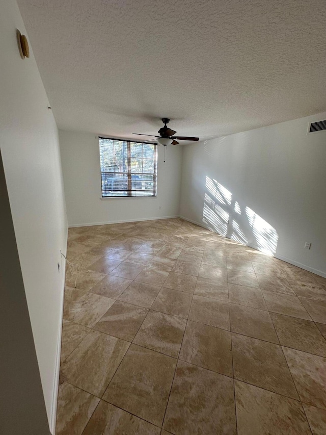 unfurnished room with a textured ceiling and ceiling fan