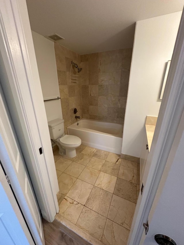 full bathroom with toilet, vanity, and tiled shower / bath