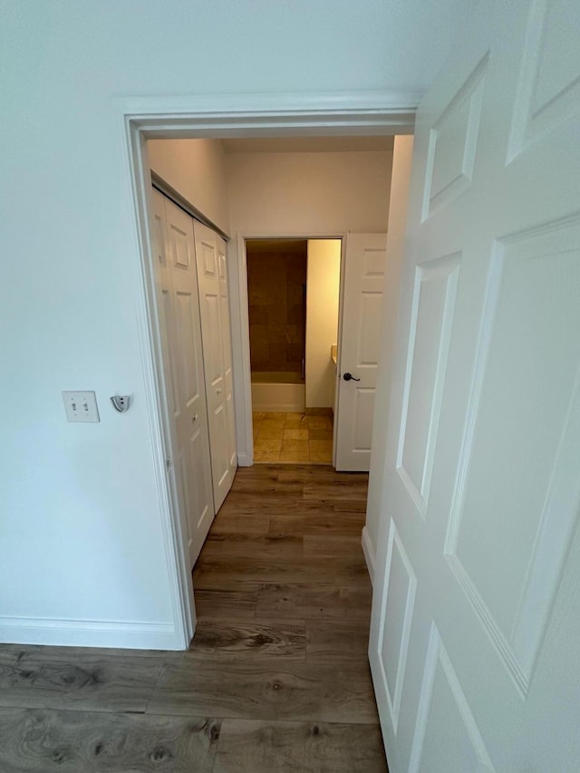 hallway featuring dark hardwood / wood-style flooring