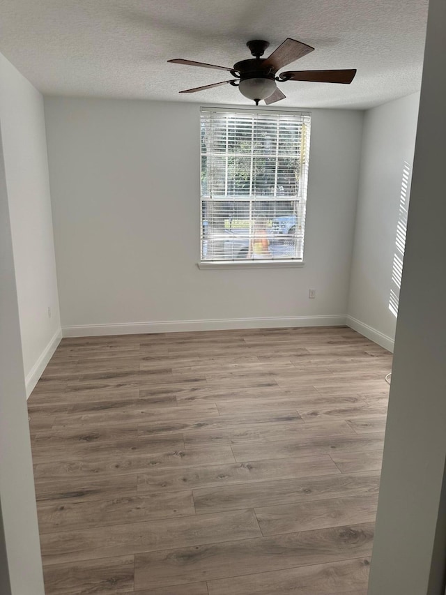 unfurnished room featuring light hardwood / wood-style flooring, a textured ceiling, and ceiling fan