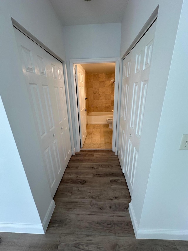 hall with dark wood-type flooring