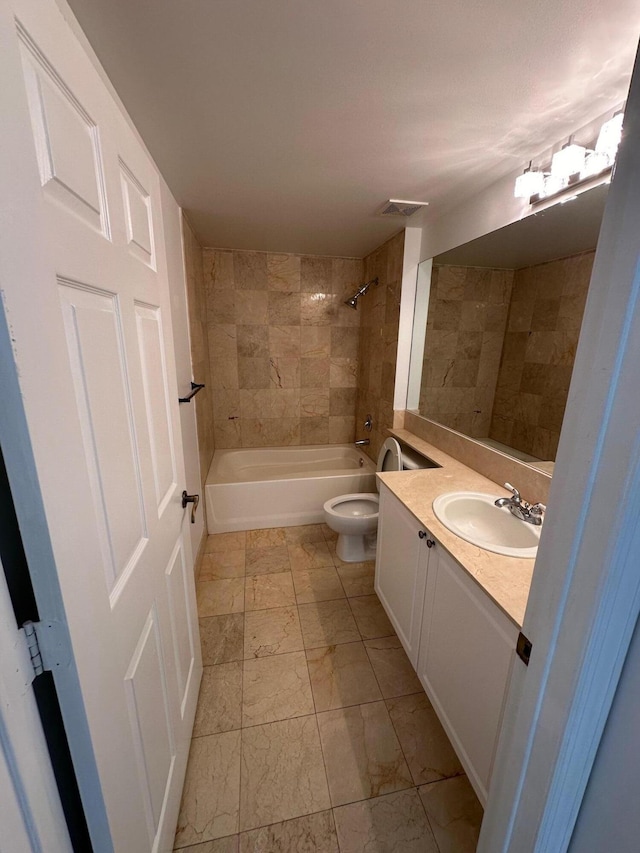 full bathroom with vanity, tiled shower / bath combo, and toilet