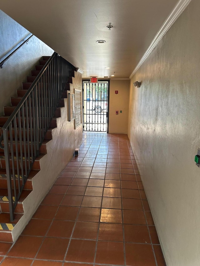 interior space featuring tile patterned flooring and ornamental molding