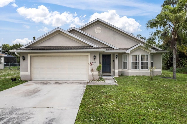 view of front of property with a front yard and a garage