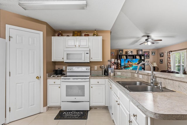 kitchen featuring white appliances, kitchen peninsula, ceiling fan, white cabinets, and sink