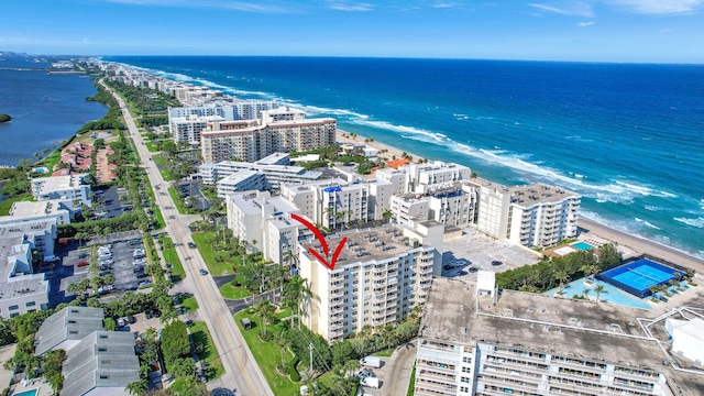 drone / aerial view featuring a water view and a view of city