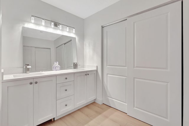 full bath with a sink and double vanity