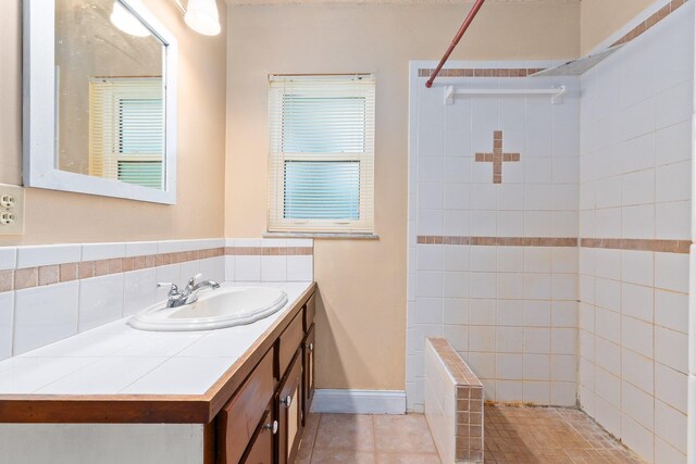 bathroom with vanity, tile patterned floors, and tiled shower