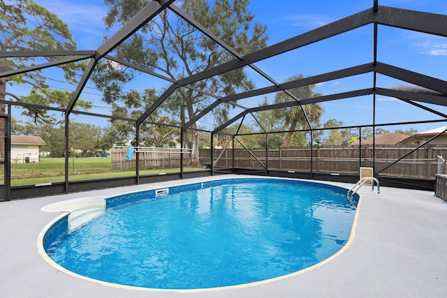 view of swimming pool with glass enclosure