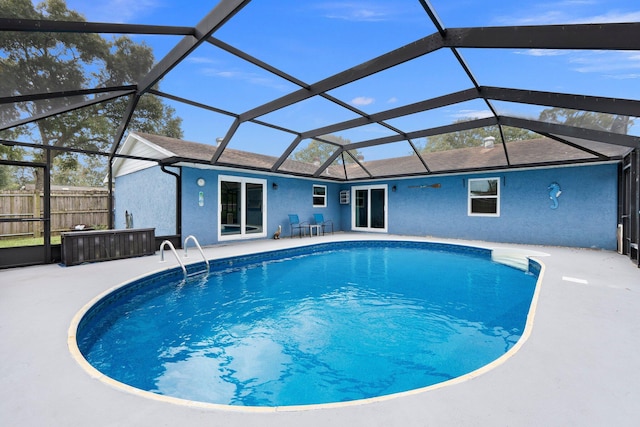 view of swimming pool featuring a lanai and a patio