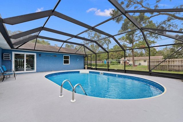 view of swimming pool with a lanai and a patio area