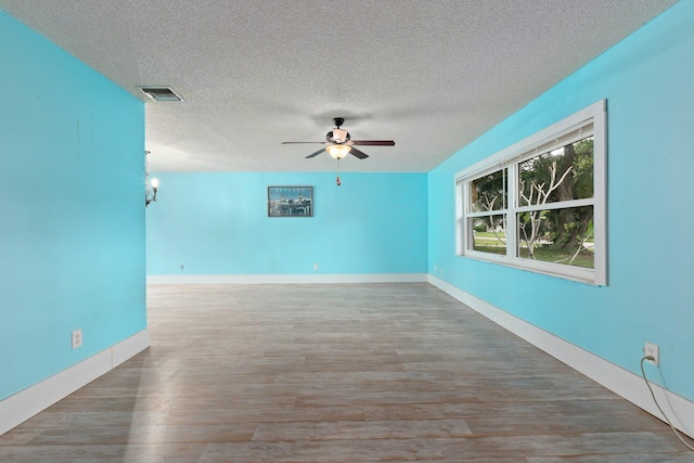 unfurnished living room with a textured ceiling, hardwood / wood-style flooring, and ceiling fan