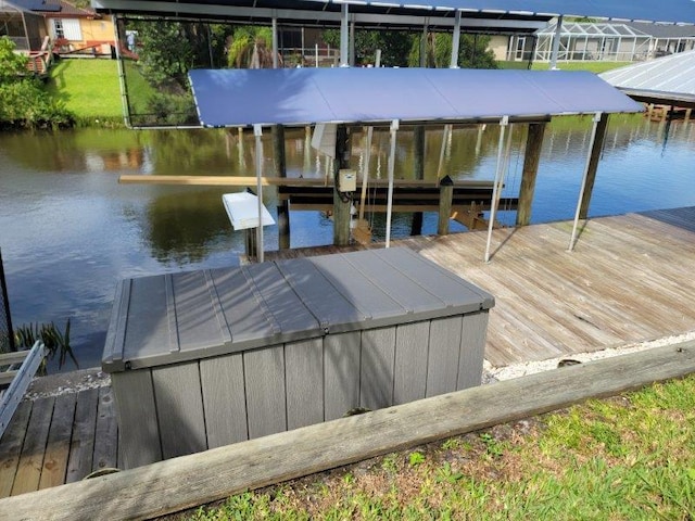 view of dock with boat lift and a water view