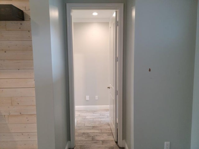 hallway with baseboards and wood finished floors