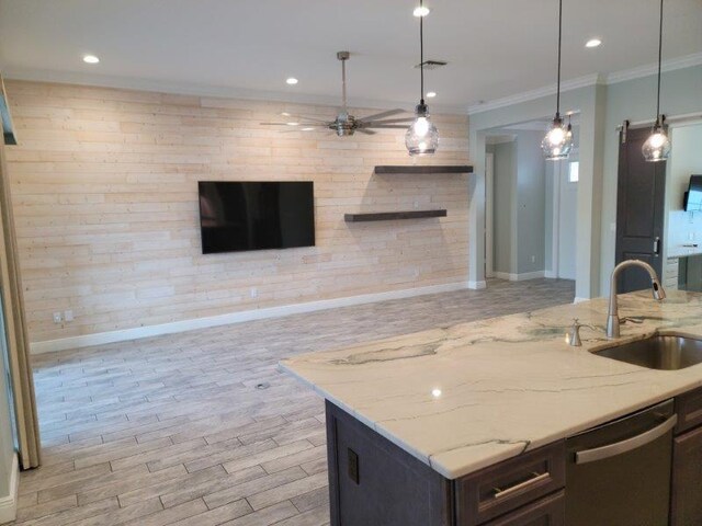 kitchen with visible vents, ornamental molding, a sink, stainless steel dishwasher, and open floor plan