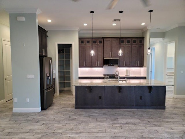 kitchen with light wood-style floors, stainless steel appliances, backsplash, and visible vents