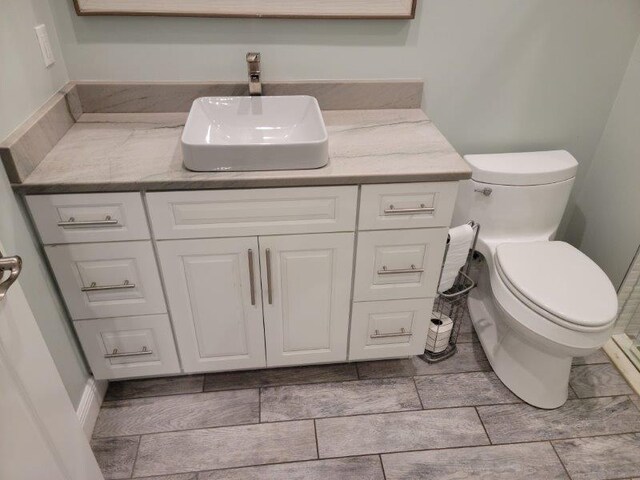 bathroom with toilet and vanity