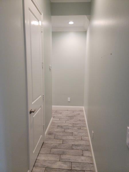 hall featuring recessed lighting, crown molding, baseboards, and wood tiled floor