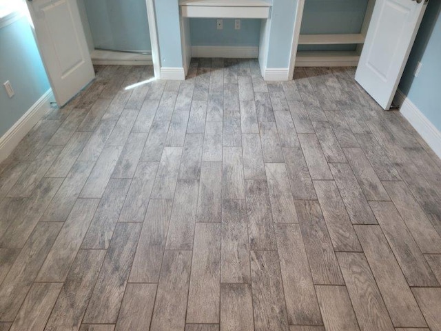 room details featuring baseboards and wood finish floors