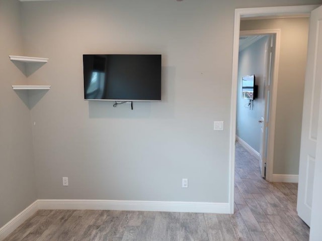 unfurnished bedroom with baseboards and wood finished floors