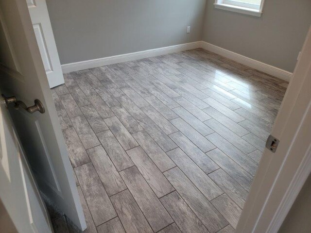 room details featuring baseboards and wood finished floors