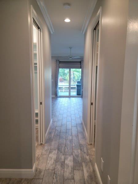 hall with wood tiled floor, recessed lighting, baseboards, and ornamental molding