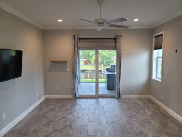 interior space with crown molding, recessed lighting, wood finished floors, and baseboards