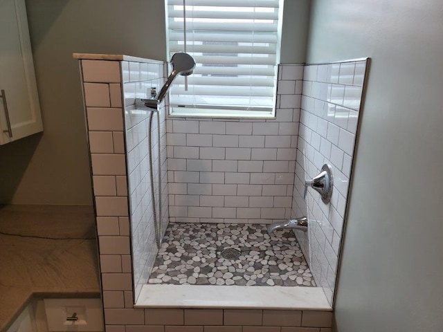 full bath featuring a tile shower