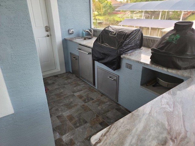 view of patio with a sink, grilling area, and an outdoor kitchen