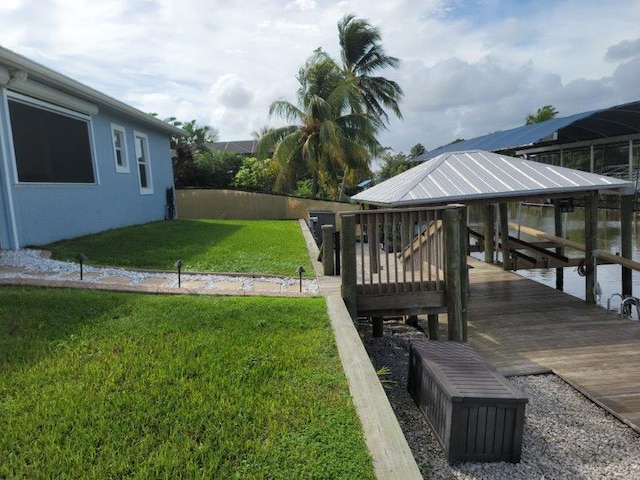 view of yard featuring a dock and boat lift