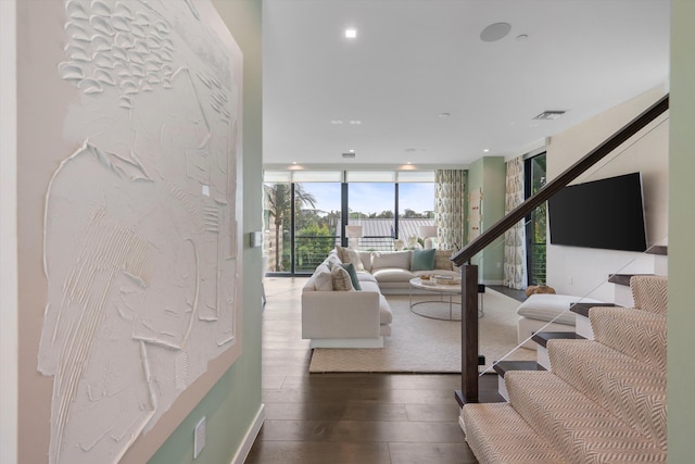 living room with hardwood / wood-style flooring and expansive windows