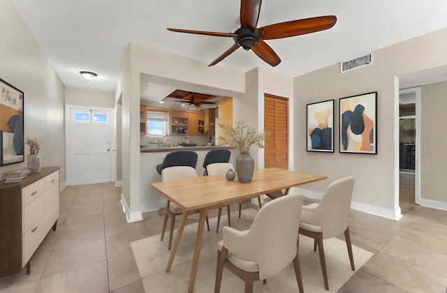 tiled dining space with ceiling fan