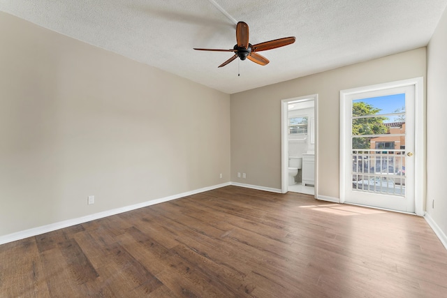 empty room featuring ceiling fan, wood-type flooring, and a textured ceiling